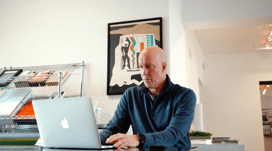 Man at desk using laptop